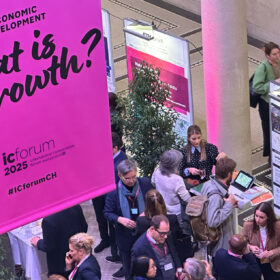 People talking to each other and a banner of Urban Digital Twin Sarajevo at the IC Forum 2025 Marketspace in the ETH Main Building Säulenhallen, Credit: Dr. Michael Walczak, ETH Zurich Klumpner Chair of Architecture and Urban Design